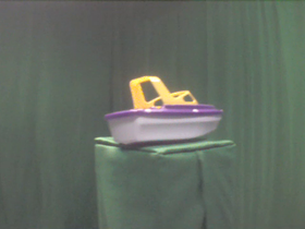 315 Degrees _ Picture 9 _ Purple and Yellow Toy Boat.png